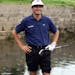 FILE - In this July 18, 1999, file photo, France's Jean Van de Velde smiles as he stands in the water of the Barry Burn that crosses the 18th fairway 