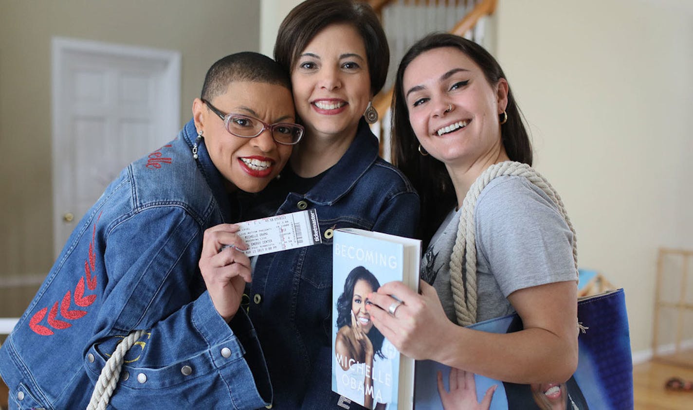 Sheletta Brundidge and five of her friends started a book club to read Michelle Obama's BECOMING. Now they all have tickets to the upcoming Michelle Obama event in at the Xcel Energy Center in St. Paul on March 13 and have loaded themselves up with Michelle gear. Here, Sheletta Brundidge, left, and friends Charlotte Larson, right to left, of Hopkins and Heather Belair of New Brighton, posed with some of their swag at Brundidge's home where they came to prepare for and to talk about the big event