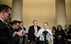 Rep. Jim Jordan (R-Ohio), center, and Rep. Mark Meadows (R-N.C.) speak to reporters after a House Intelligence Committee on the impeachment inquiry in