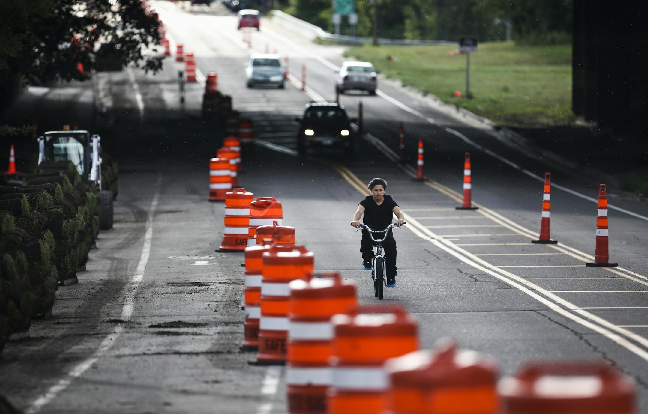 A bicyclist road on the outskirts of construction of the bicycle boulevard being built on Jefferson Avenue, on Monday, August 11, 2014, in St. Paul, Minn. ] RENEE JONES SCHNEIDER ‚Ä¢ reneejones@startribune.com