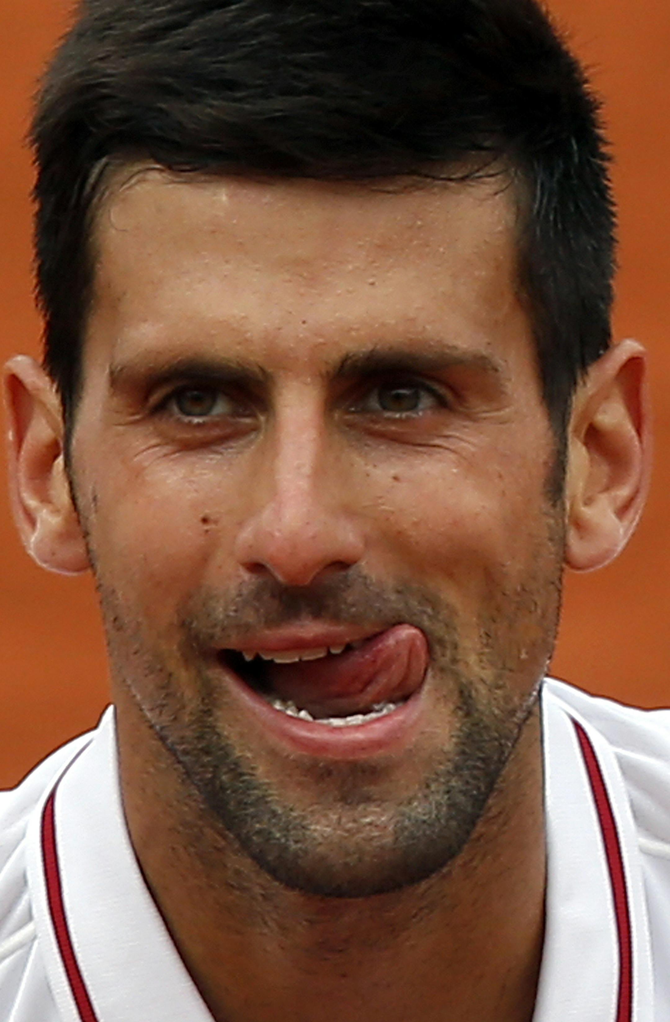 Serbia's Novak Djokovic sticks his tongue out as he cheers the audience after defeating Belgium’s Steve Darcis during their second round match of the French Open tennis tournament at the Roland Garros stadium, Thursday, May 26, 2016 in Paris. Djokovic won 7-5, 6-3, 6-4. (AP Photo/Michel Euler)