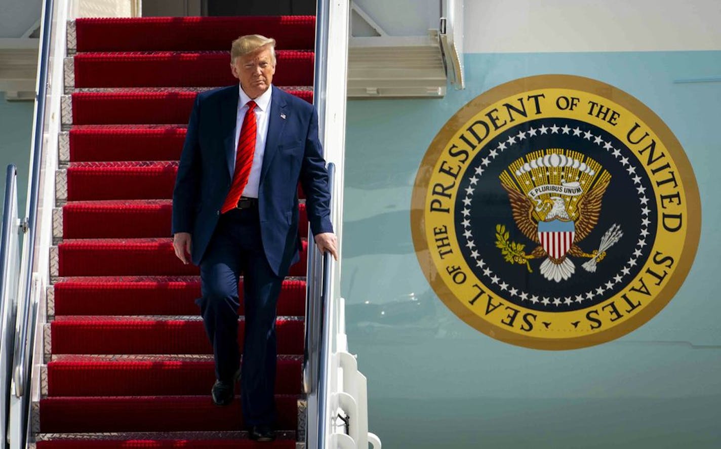 President Donald Trump walks off Air Force One at Joint Base Andrews in Maryland after a flight from New York on last month.