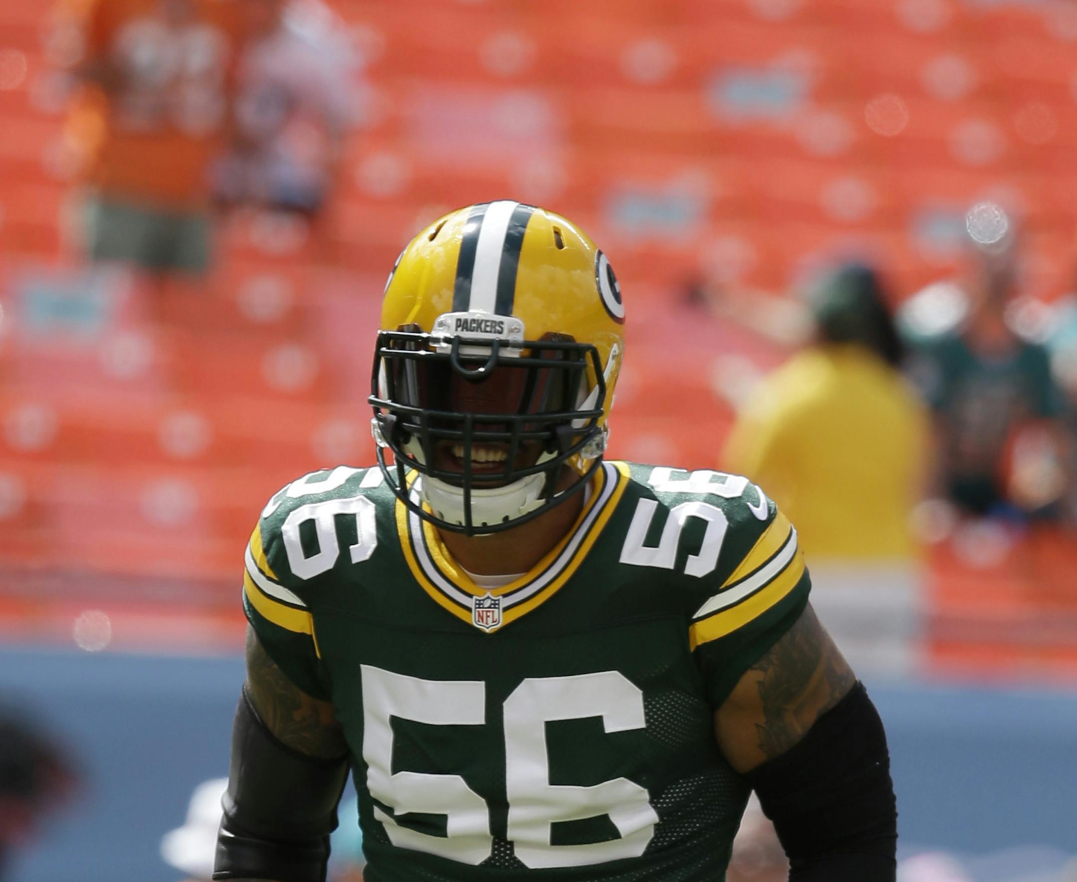 Green Bay Packers outside linebacker Julius Peppers (56) runs on the field before an NFL football game against the Miami Dolphins, Sunday, Oct. 12, 2014, in Miami Gardens, Fla. (AP Photo/Lynne Sladky)