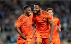 Houston defender Micael celebrates his first-half goal against Minnesota United with teammate Latif Blessing on Saturday night in St. Paul.