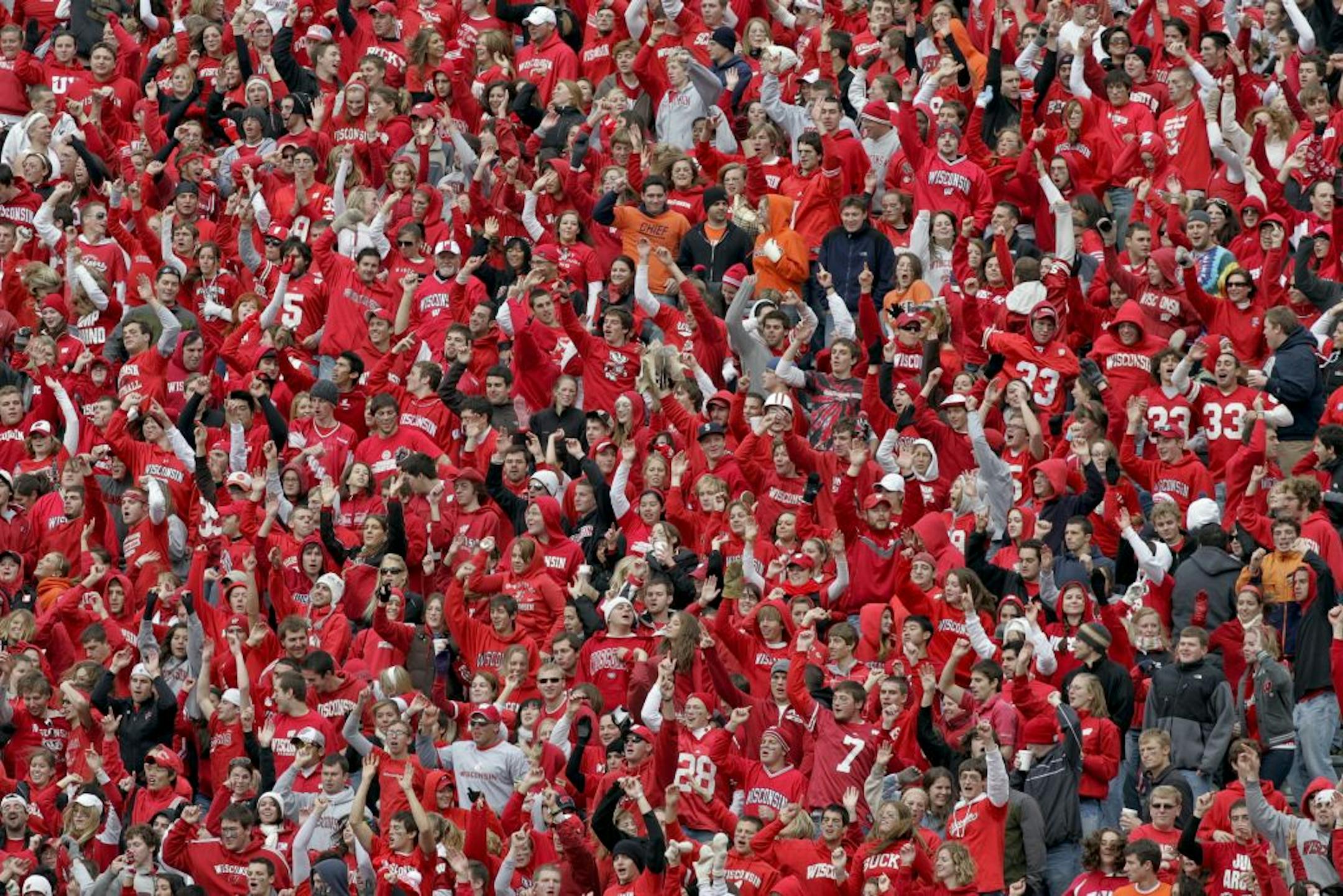 FILE - In this Oct. 25, 2008, file photo, Wisconsin fans dance to "Jump Around" during an NCAA college football game against Illinois in Madison, Wis. Jump Around," House of Pain's one great contribution to hip-hop music was released in 1992 and not long after, Wisconsin used it to create one of the most raucous moments in college sports. Between the third and fourth quarters, as "Jump Around" blares, Badgers fans start bouncing and Camp Randall Stadium practically starts shaking.