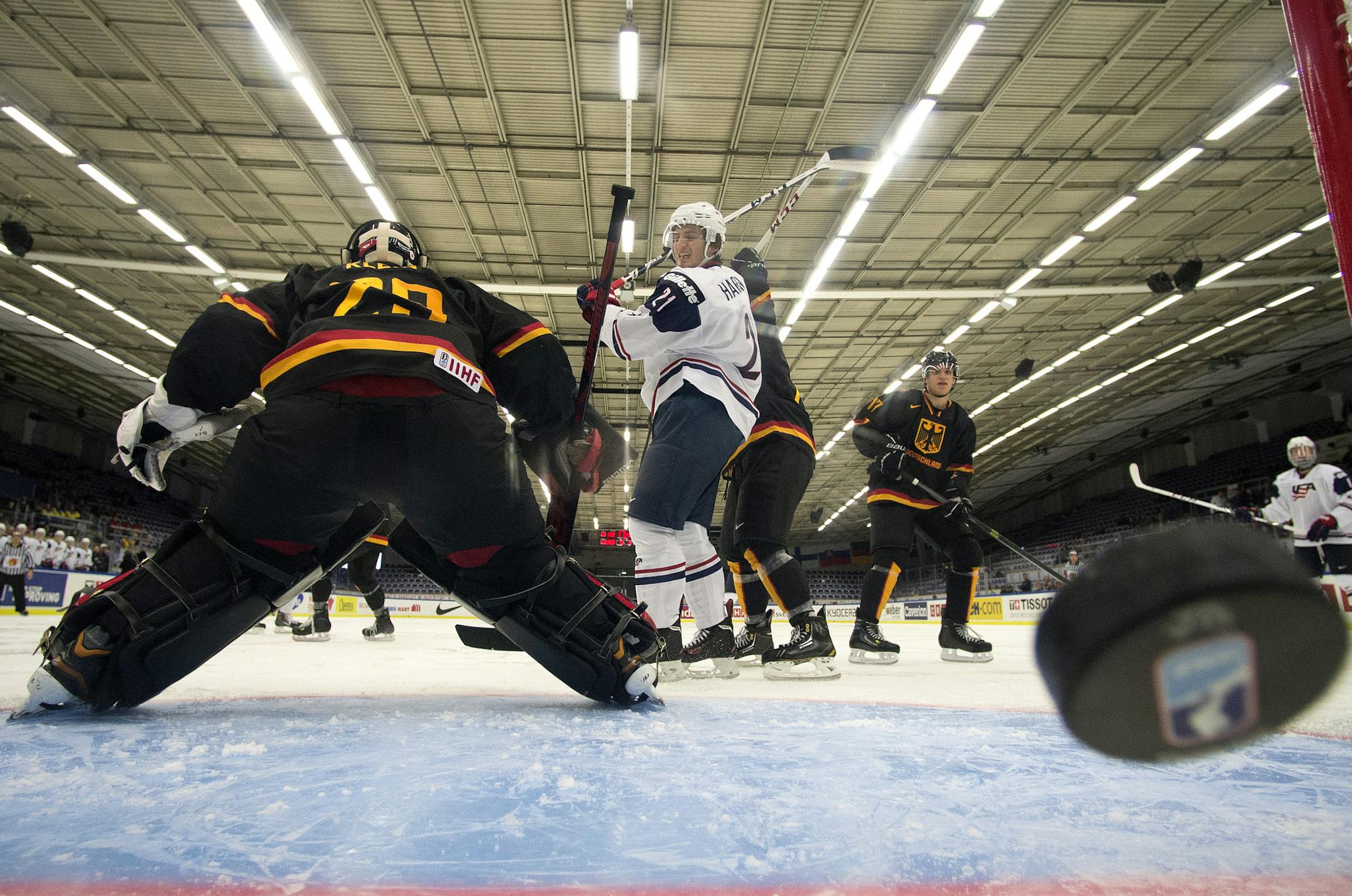 USA forward Ryan Hartman (21) celebrates a goal as the puck gets past Germany goaltender Patrick Klein and forward Frederik Tiffels (17) during the second period of a World Junior hockey game in Malmo, Sweden on Sunday, Dec. 29, 2013. (AP Photo/The Canadian Press, Frank Gunn)