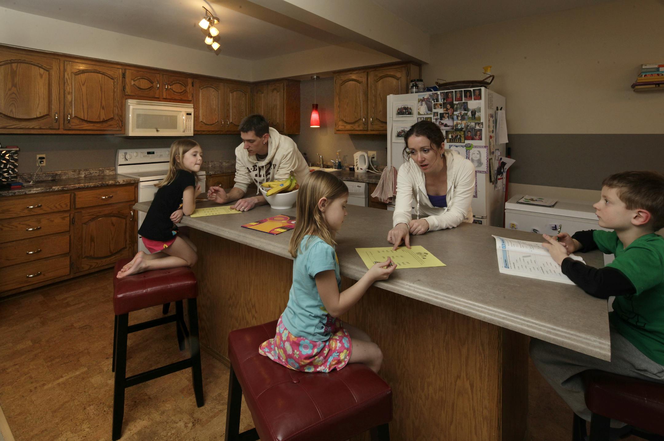 (Left to right) Jada (5 years old, black shirt), Steve Bennett (father), Jess Bennett (mother), Blake (7 years old) and Bella (5 years old, blue shirt) in their renovated kitchen. Coon Rapids, MN home on March 27, 2013. ] JOELKOYAMA‚Ä¢joel koyama@startribune.com Cruise around Coon Rapids and some of its established neighborhoods can feel a bit Brady Bunch. The city was built out in the 1960s and 70s when the split level and rambler where at the height of suburban splendor. In an