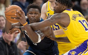 Wolves shooting guard Anthony Edwards, left, works against Lakers forward Dorian Finney-Smith during Game 3 of their first-round playoff series on Apr
