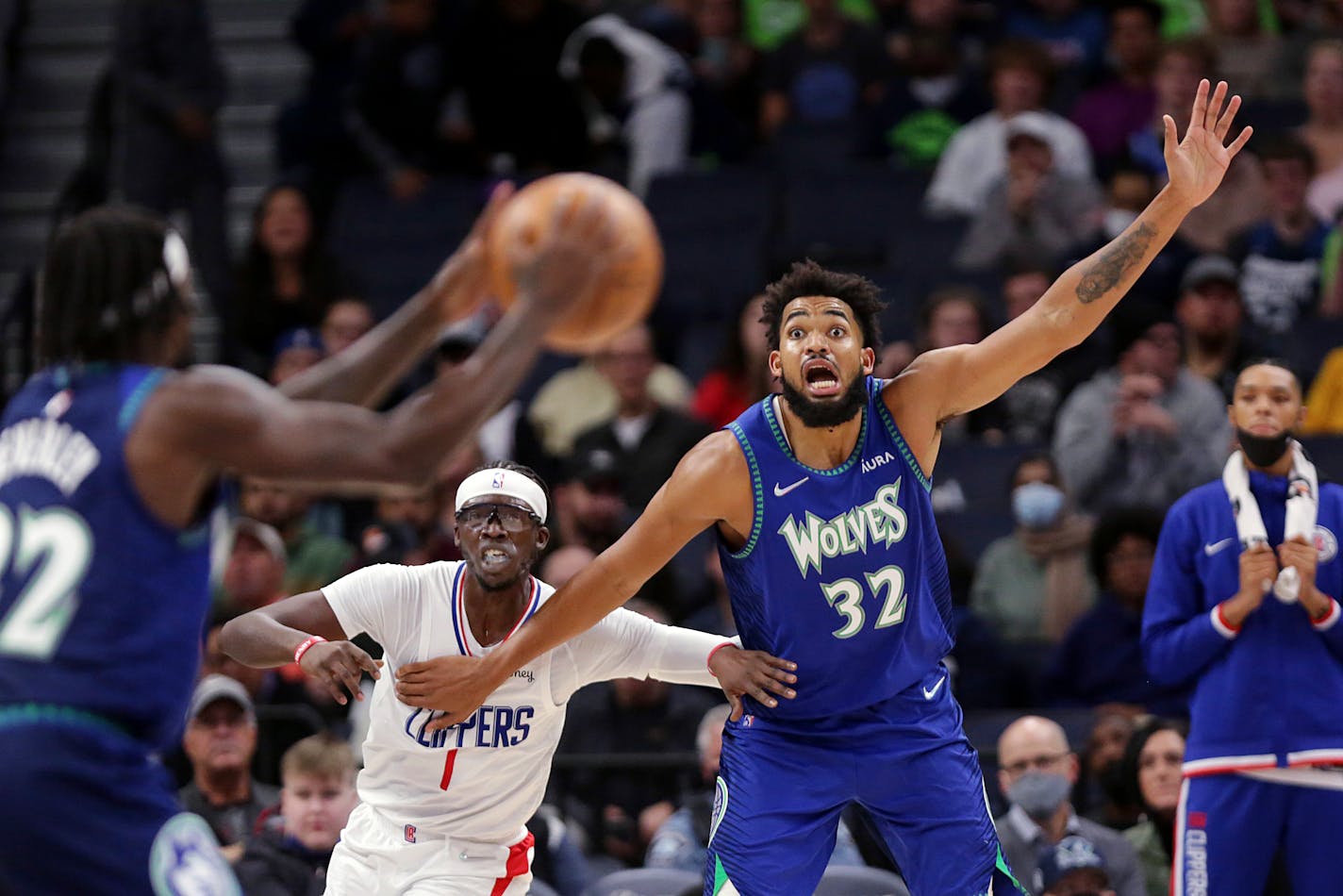 Minnesota Timberwolves center Karl-Anthony Towns (32) calls for the ball from guard Patrick Beverley (22) with Los Angeles Clippers guard Reggie Jackson (1) defends during the second half of an NBA basketball game, Friday, Nov. 5, 2021, in Minneapolis. (AP Photo/Andy Clayton-King)