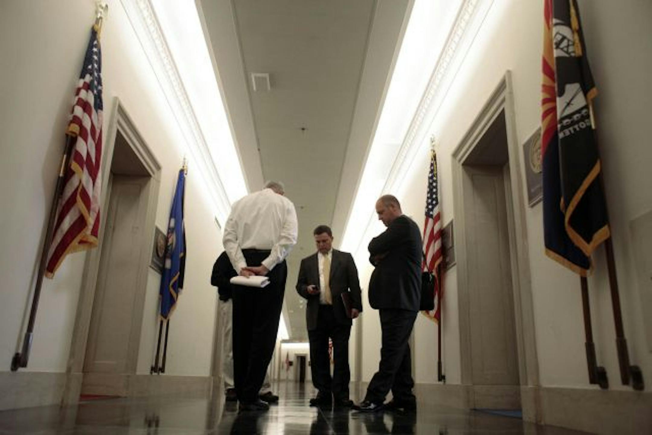 Scott Preusse, Scott Lambert of the Minnesota Automobile Dealers Association and George McGuire helped work to save dealerships. "It was high drama and very scary," Lambert said.
