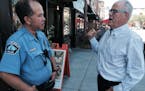 Veteran beat Officer Elliot Wong and business owner Tom Dupont on E. Hennepin Avenue in lower northeast Minneapolis. Photo: Neal.St.Anthony@startribun
