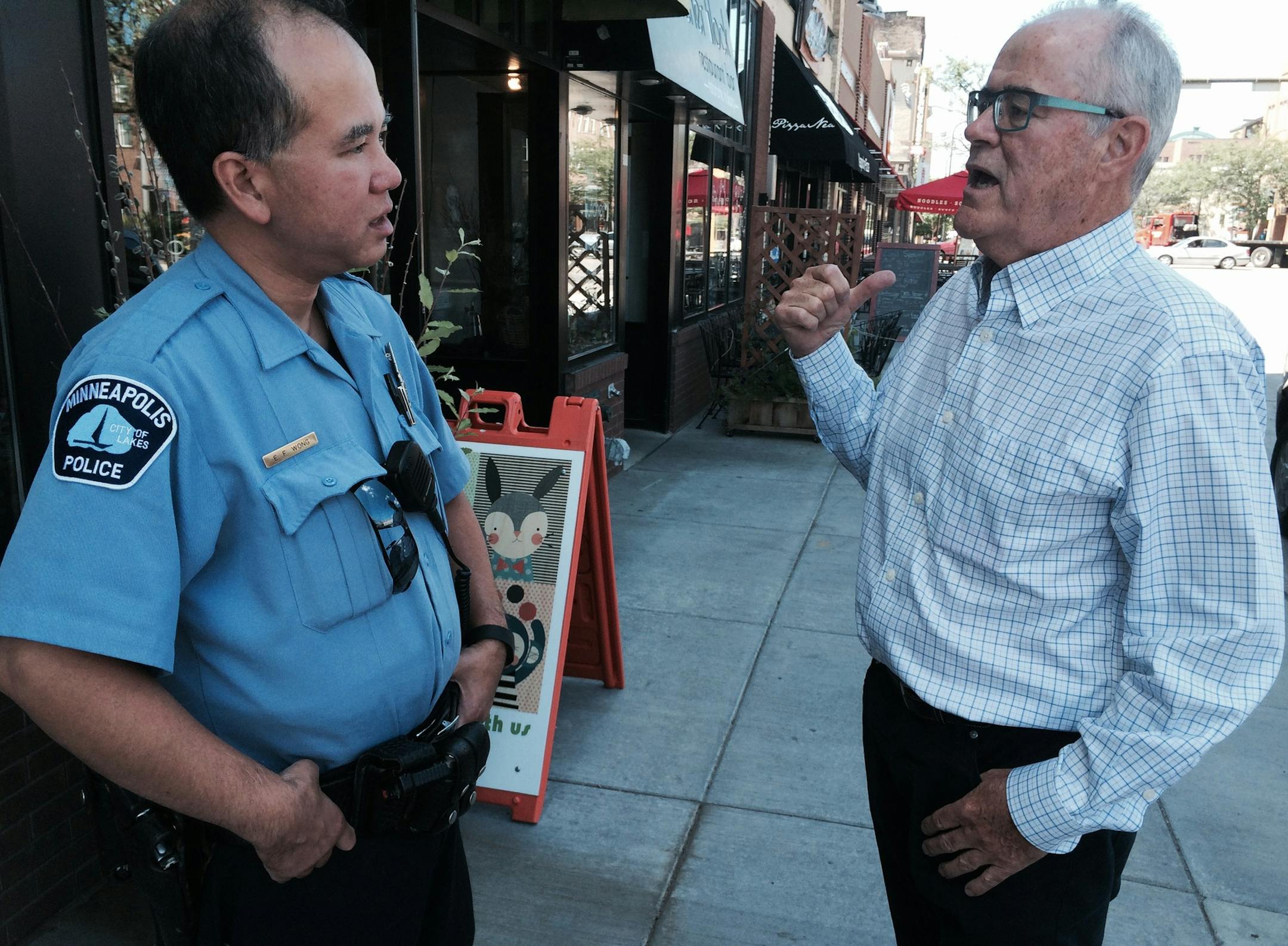 Veteran beat Officer Elliot Wong and business owner Tom Dupont on E. Hennepin Avenue in lower northeast Minneapolis. Photo: Neal.St.Anthony@startribune.com.