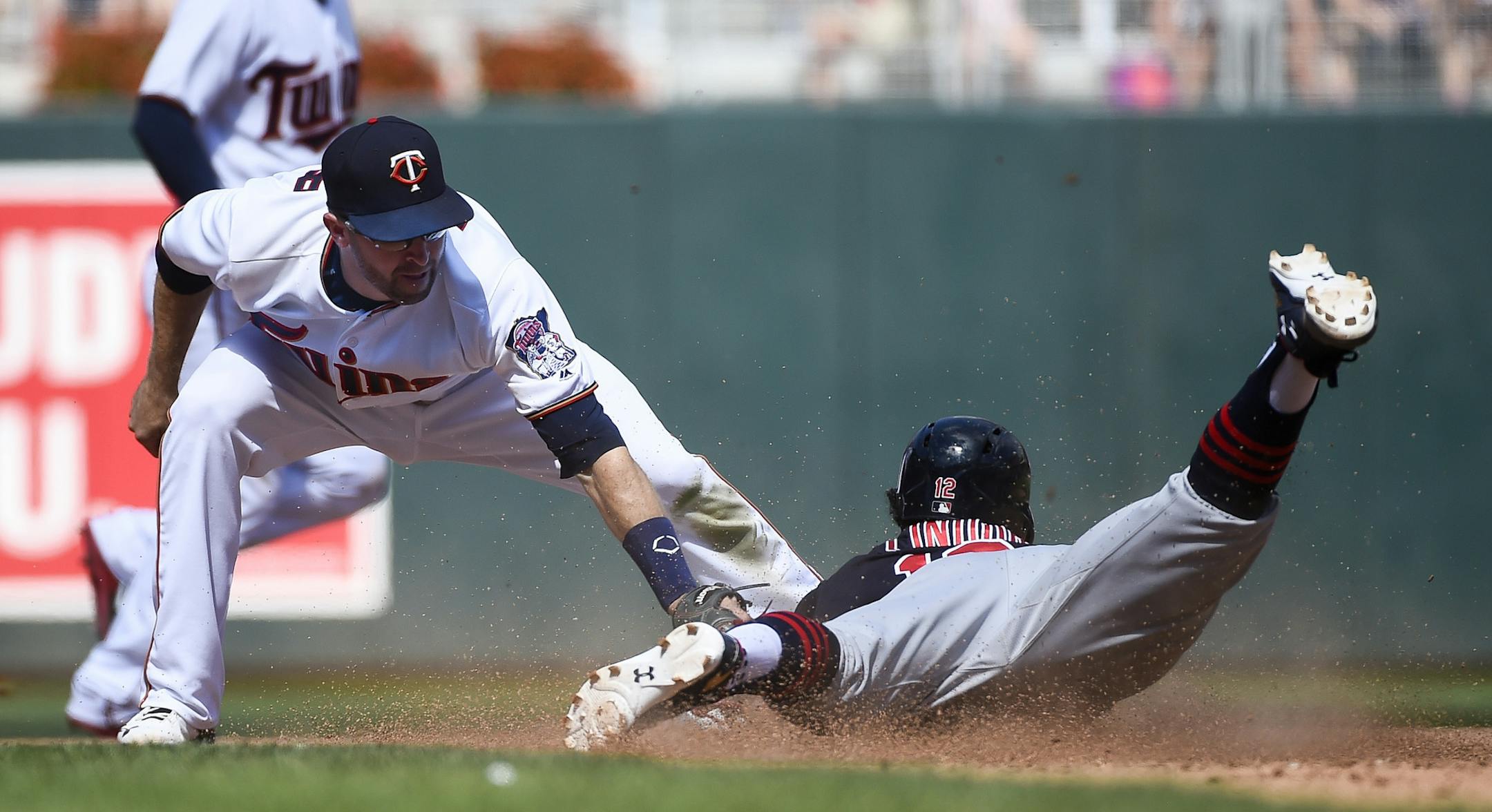 Minnesota Twins second baseman Brian Dozier tags out Cleveland Indians' Francisco Lindor who was trying to steal second base during the seventh inning of a baseball game Sunday, July 17, 2016, in Minneapolis. (AP Photo/Craig Lassig)