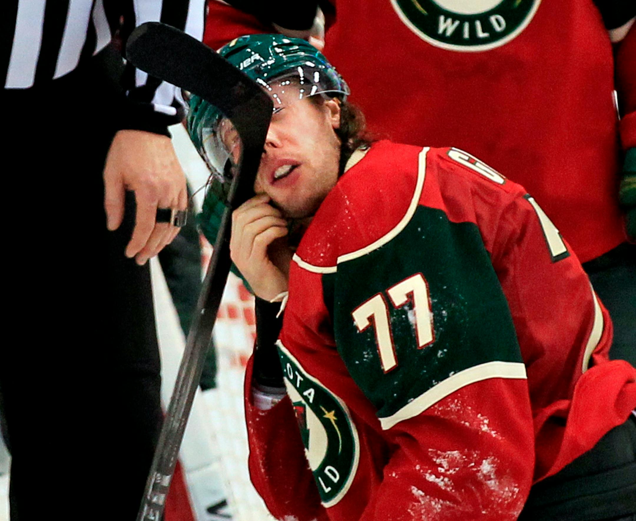 Tom Gilbert (77) had a stick stuck in his face mask in the third period. Minnesota beat Florida by a final score of 3-2 in overtime. ] CARLOS GONZALEZ cgonzalez@startribune.com, March 29, 2012, St. Paul, Minn, NHL, Xcel Energy Center, Minnesota Wild vs. Florida Panthers