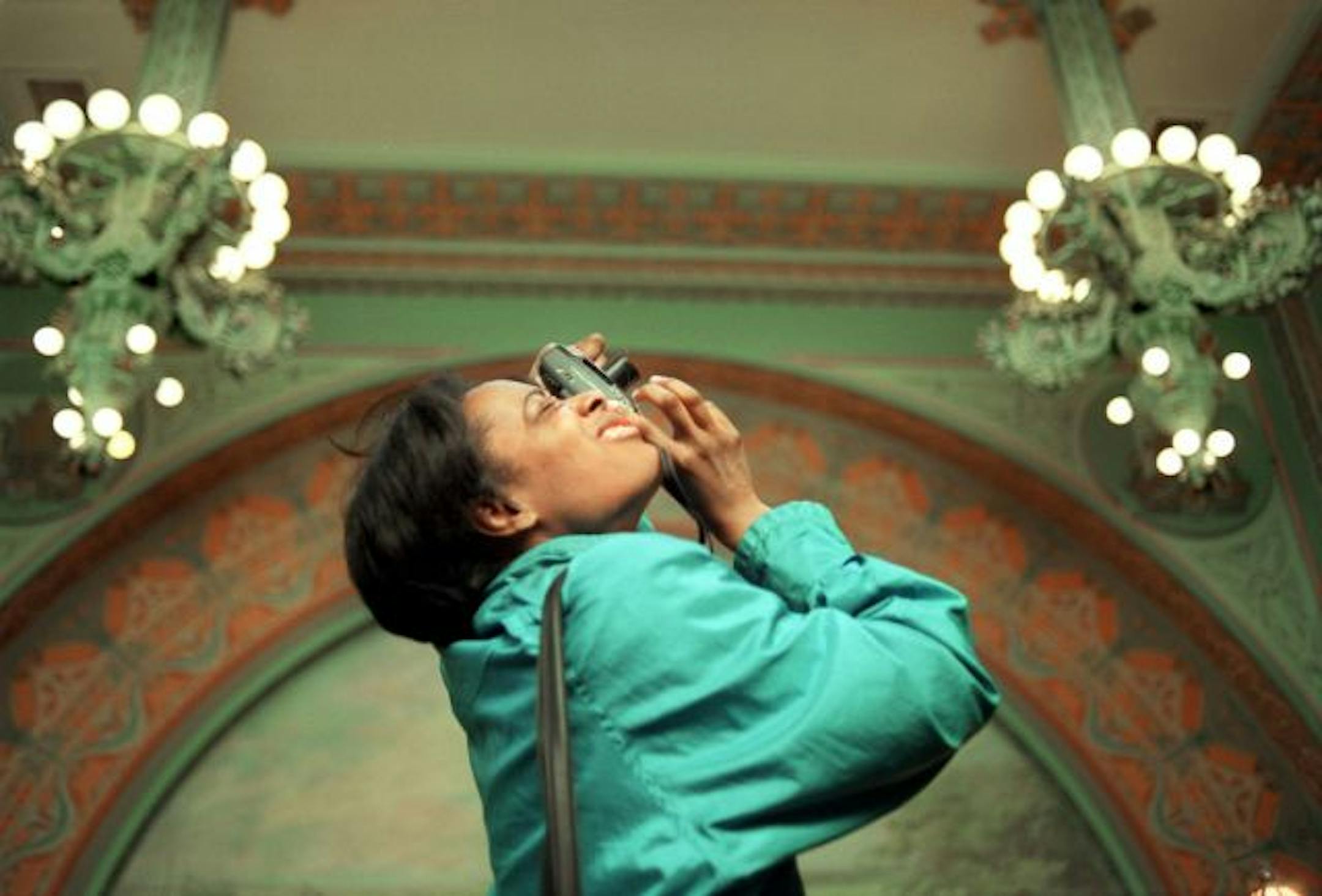 Ruth Foster, a computer drafting technician from Minneapolis and a Frank Llyod Wright fan, takes a picture of the details inside Louis Sullivan's Owatonna bank.