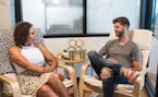 Rob Lawless, right, sits down with Dalina Soto, left, owner of Nutritiously Yours, at Soto's office in WeWork's Northern Liberties location in Philade