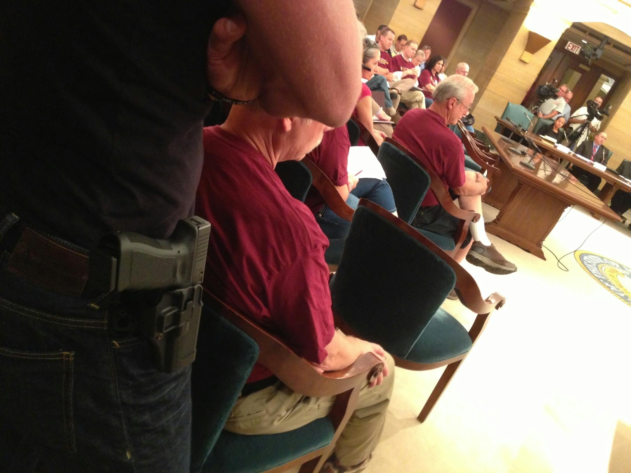 A man wore a gun on his hip as he attended a hearing about whether to restrict the carrying of weapons at the State Capitol.