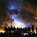 Black smoke rise during clashes between protesters and police in central Kiev, Ukraine, early Saturday, Jan. 25, 2014. As riots spread from Ukraine's 