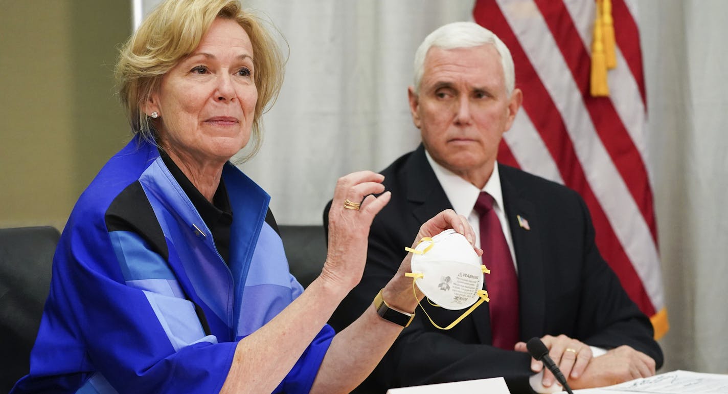 Dr. Deborah Birx, White House coronavirus response coordinator, holds a 3M N95 mask as she and Vice President Mike Pence visited 3M headquarters in Maplewood on March 5.