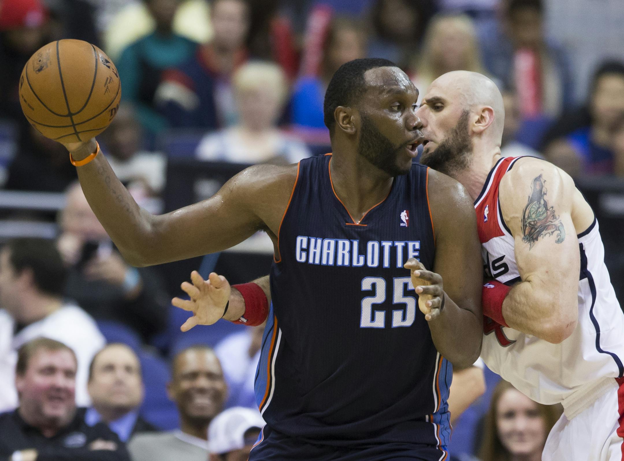 Charlotte Bobcats center Al Jefferson (25) is defended by Washington Wizards center Marcin Gortat during the second half of an NBA basketball game on Wednesday, March 12, 2014, in Washington. The Bobcats defeated the Wizards 98-85. (AP Photo/ Evan Vucci)