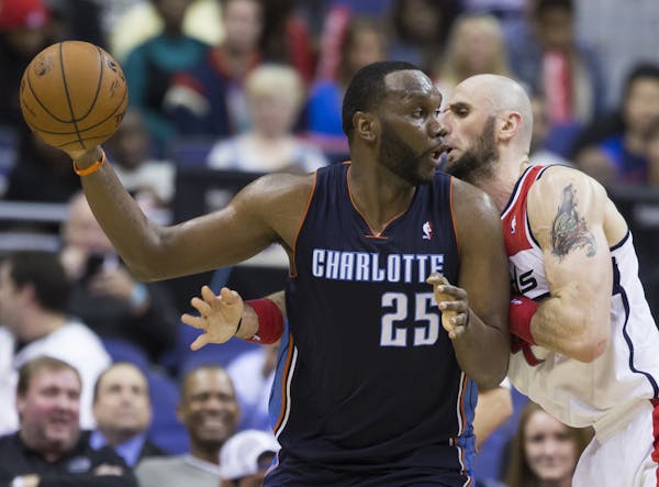 Charlotte Bobcats center Al Jefferson (25) is defended by Washington Wizards center Marcin Gortat during the second half of an NBA basketball game on 