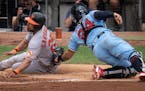 Baltimore Orioles right fielder Anthony Santander was tagged out by Minnesota Twins catcher Gary Sanchez (24) in the fourth inning.