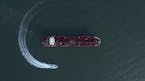In this Sunday, July 21, 2019 photo, an aerial view shows a speedboat of Iran's Revolutionary Guard moving around the British-flagged oil tanker Stena