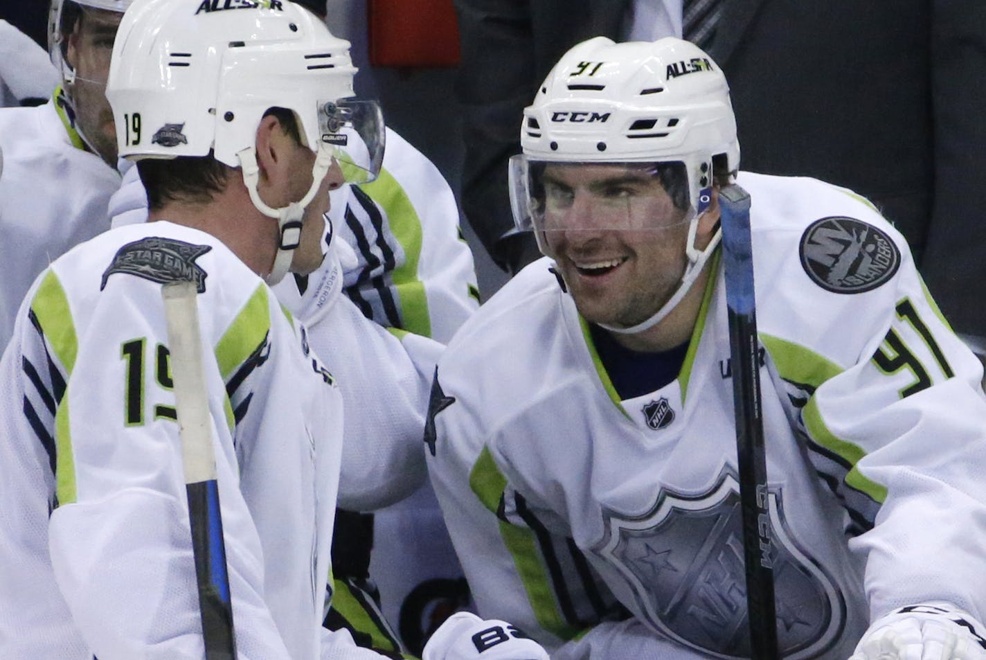 Team Toews captain Jonathan Toews (19) of the Chicago Blackhawks talks with teammate John Tavares (91) of the New York Islanders during a time out in the third period of the NHL All-Star hockey game in Columbus, Ohio, Sunday, Jan. 25, 2015. Tavares had four goals in Team Toews 17-12 win. (AP Photo/Gene J. Puskar)