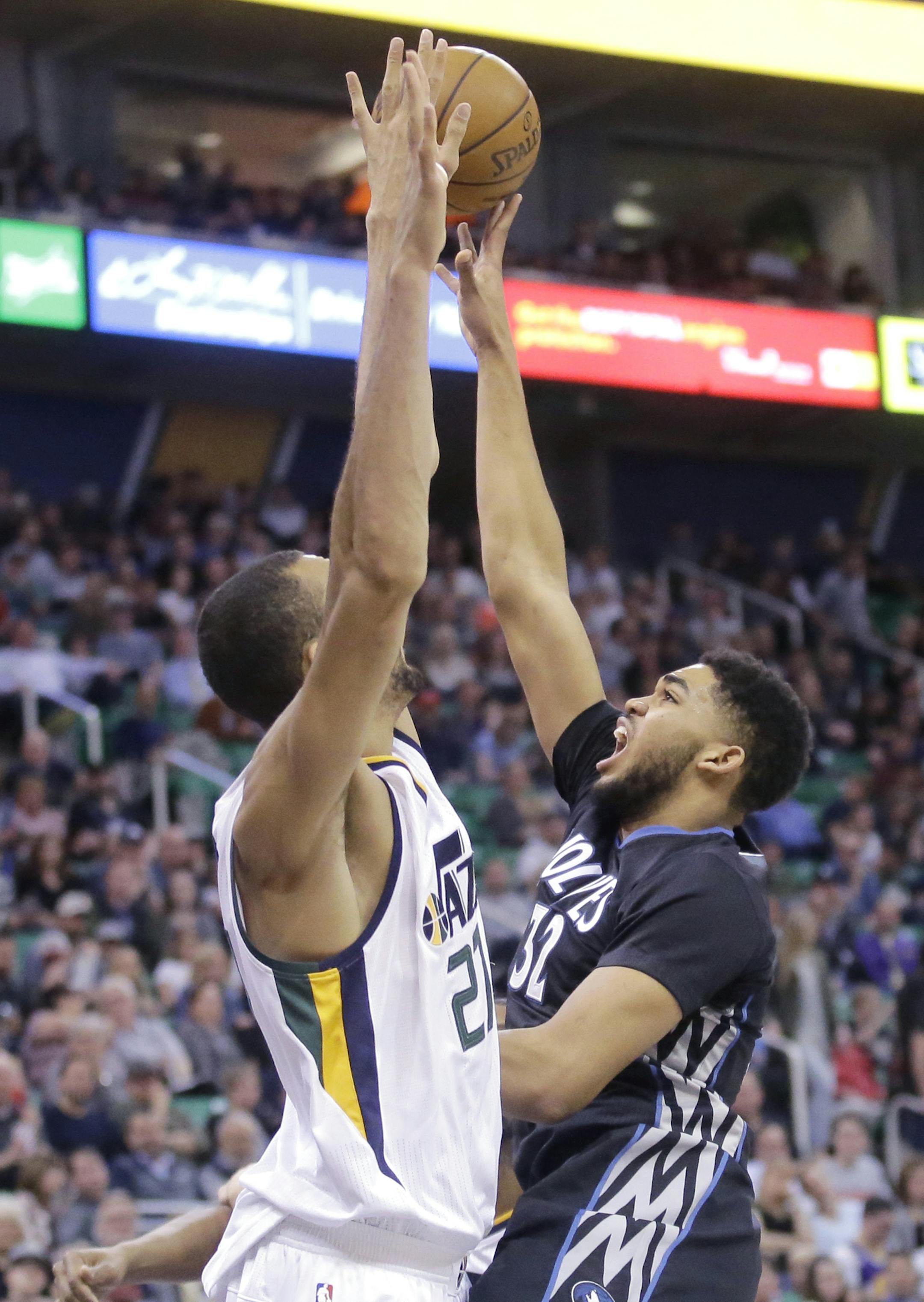 Minnesota Timberwolves center Karl-Anthony Towns (32) shoots as Utah Jazz center Rudy Gobert, left, defends during the first half in an NBA basketball game Friday, April 7, 2017, in Salt Lake City. (AP Photo/Rick Bowmer)