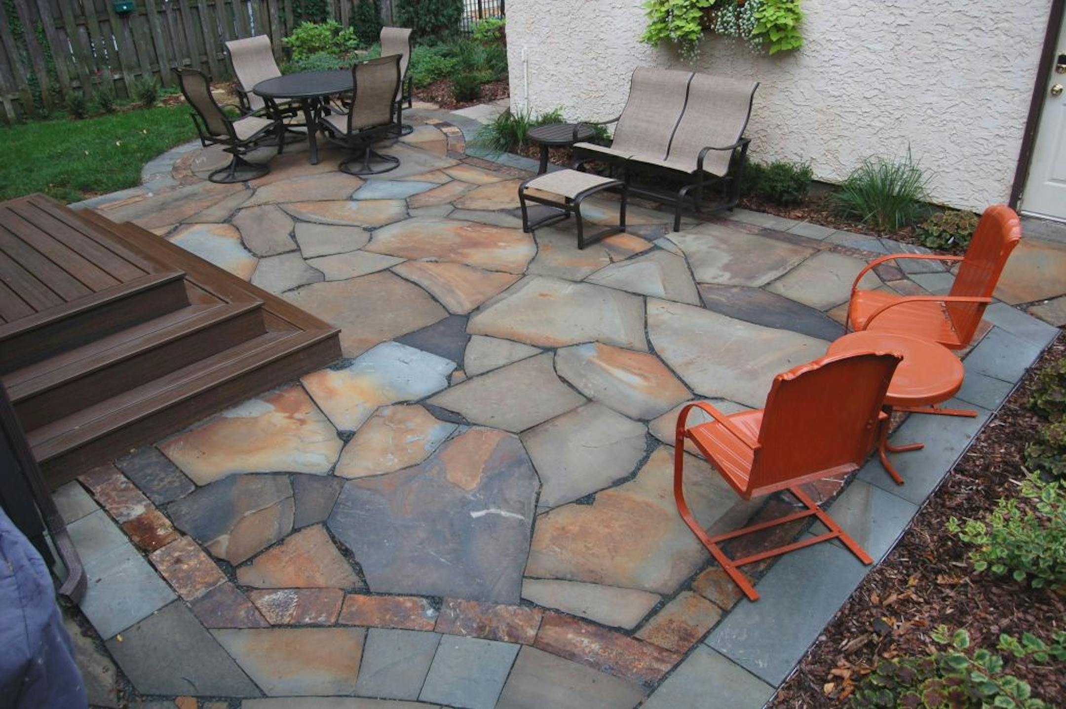 The natural stone permeable patio prevents rainwater runoff while providing a pleasant place for entertaining.