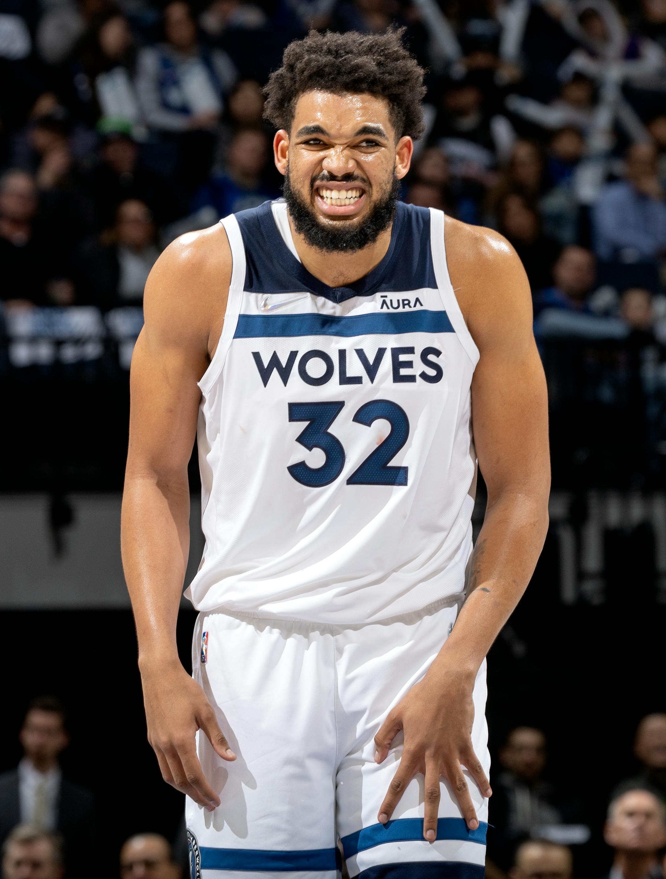 Karl Anthony-Towns (32) of the Minnesota Timberwolves winces in pain after being fouled in the first quarter.