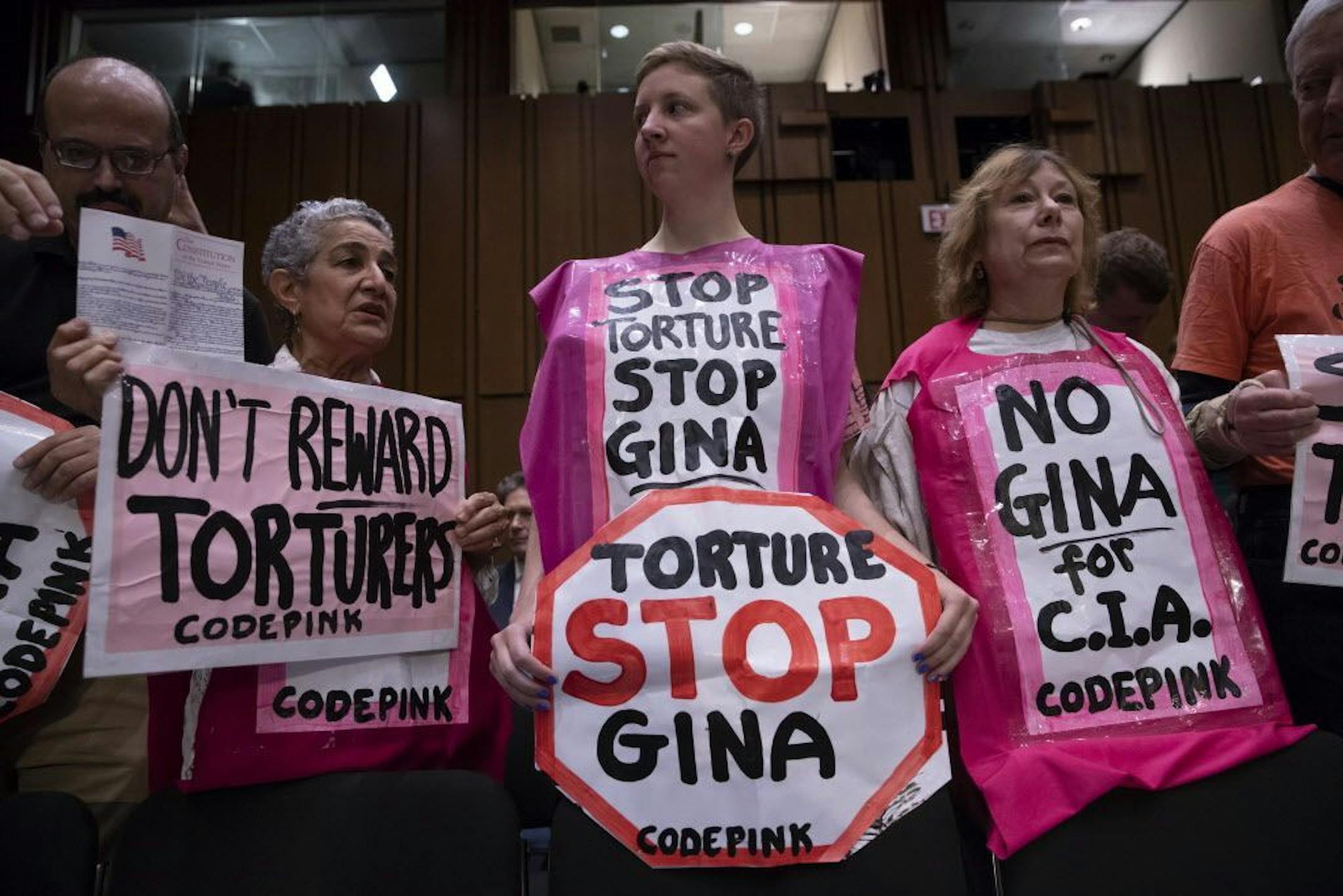 Protesters await the arrival of Gina Haspel, President Donald Trump's pick to lead the Central Intelligence Agency, at her confirmation hearing before the Senate Intelligence Committee, on Capitol Hill in Washington, Wednesday, May 9, 2018.