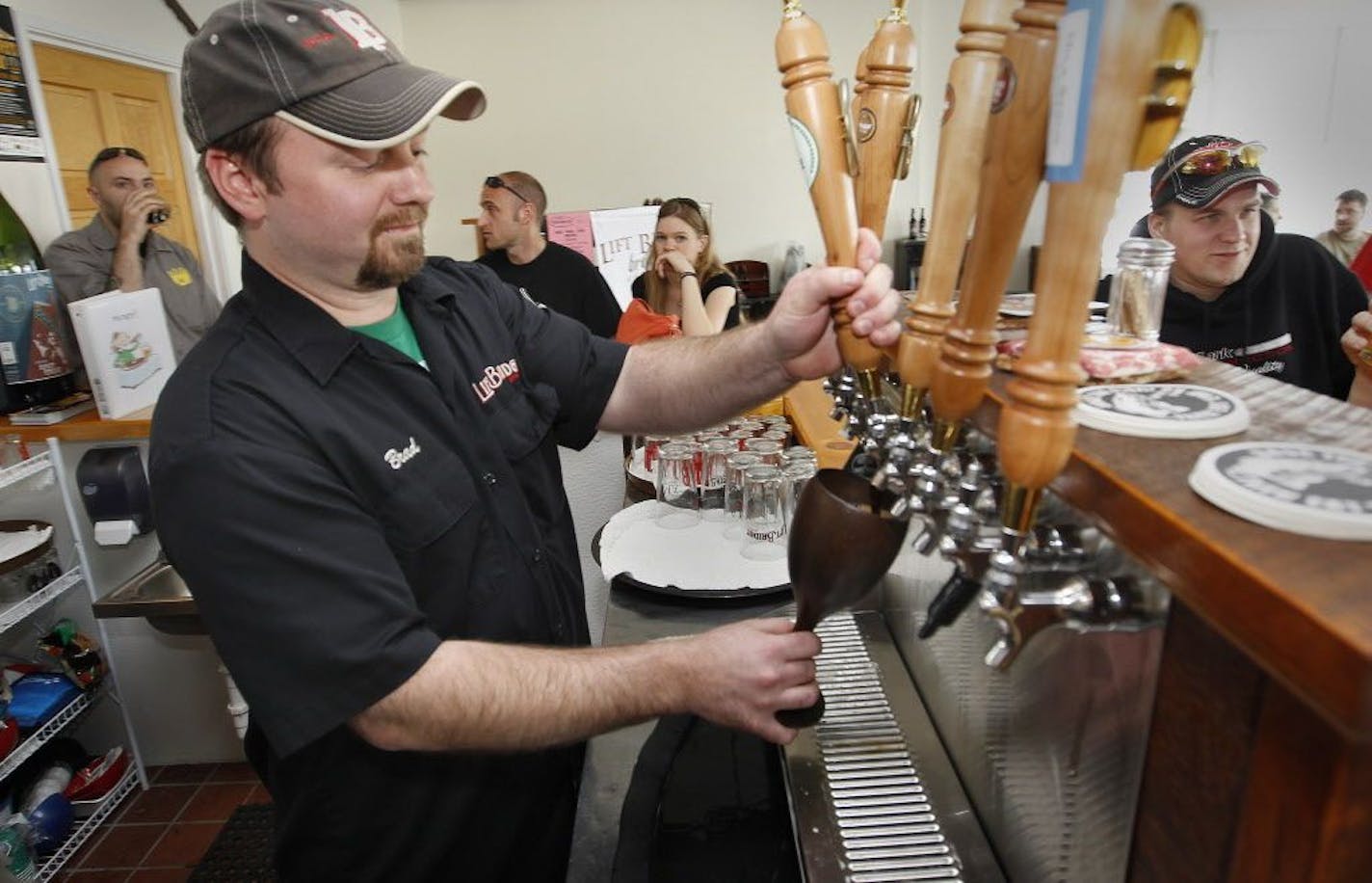 Co-owner Brad Glynn pulls a brew in the tap room of Lift Bridge Brewery in Stillwater in this file photo from April 14, 2011.