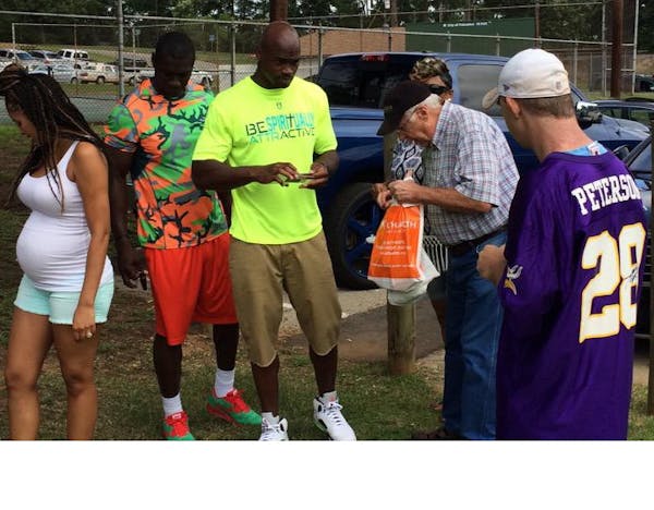 Adrian Peterson, center, and his wife, Ashley, far left, at Adrian Peterson Day on Saturday in Palestine, Texas.