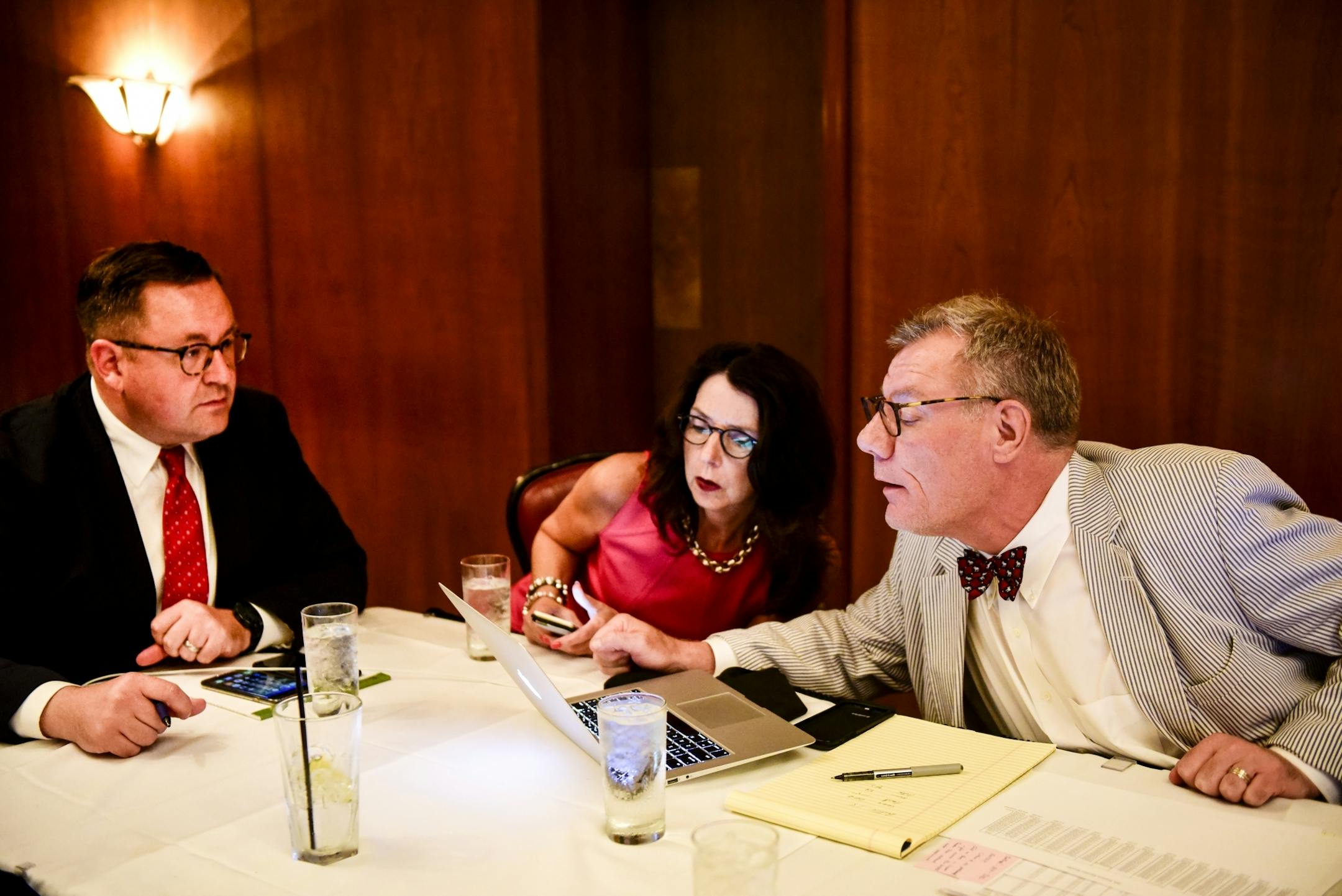 From left, Lori Swanson campaign manager Jeff Anderson and volunteers Marianne Ellis and Brian Rice looked through some of the first returns of primary voting which came from Duluth Tuesday night.