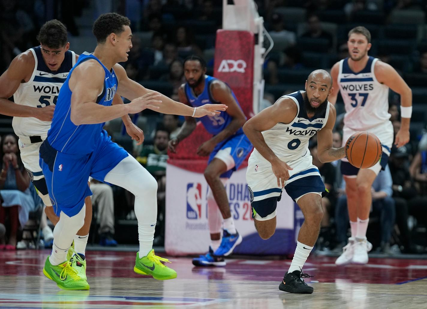 Minnesota Timberwolves' Jordan McLaughlin drives past by Dallas Mavericks' Dwight Powell during a preseason NBA basketball game between the Dallas Mavericks and Minnesota Timberwolves in Abu Dhabi, United Arab Emirates in Abu Dhabi, United Arab Emirates, Saturday, Oct. 7, 2023. (AP Photo/Kamran Jebreili)