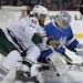 Minnesota Wild's Jordan Greenway (18) tries to recover the rebound off his shot on Winnipeg Jets goaltender Connor Hellebuyck (37) during first period