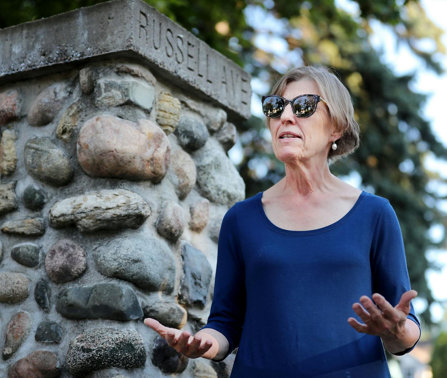 Researcher Penny Petersen stands near the stone pillar street markers that define the perimeter of the Homewood subdivision near Oak Park and Russell Avenues N. Wednesday, Aug. 17 2016, in North Minneapolis, MN. It was believed by some that in the subdivision covenant for the North Side neighborhood that Jews and blacks were excluded from owning and living there. Petersen found no such wording in the Homewood covenant but did in other neighborhood covenants for Minneapolis.](DAVID JOLES/STARTRIB