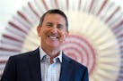 In this Aug. 21, 2015 photo, Target CEO Brian Cornell poses for a photo in front of a stylized Target logo made from baseball bats and balls at the Ci
