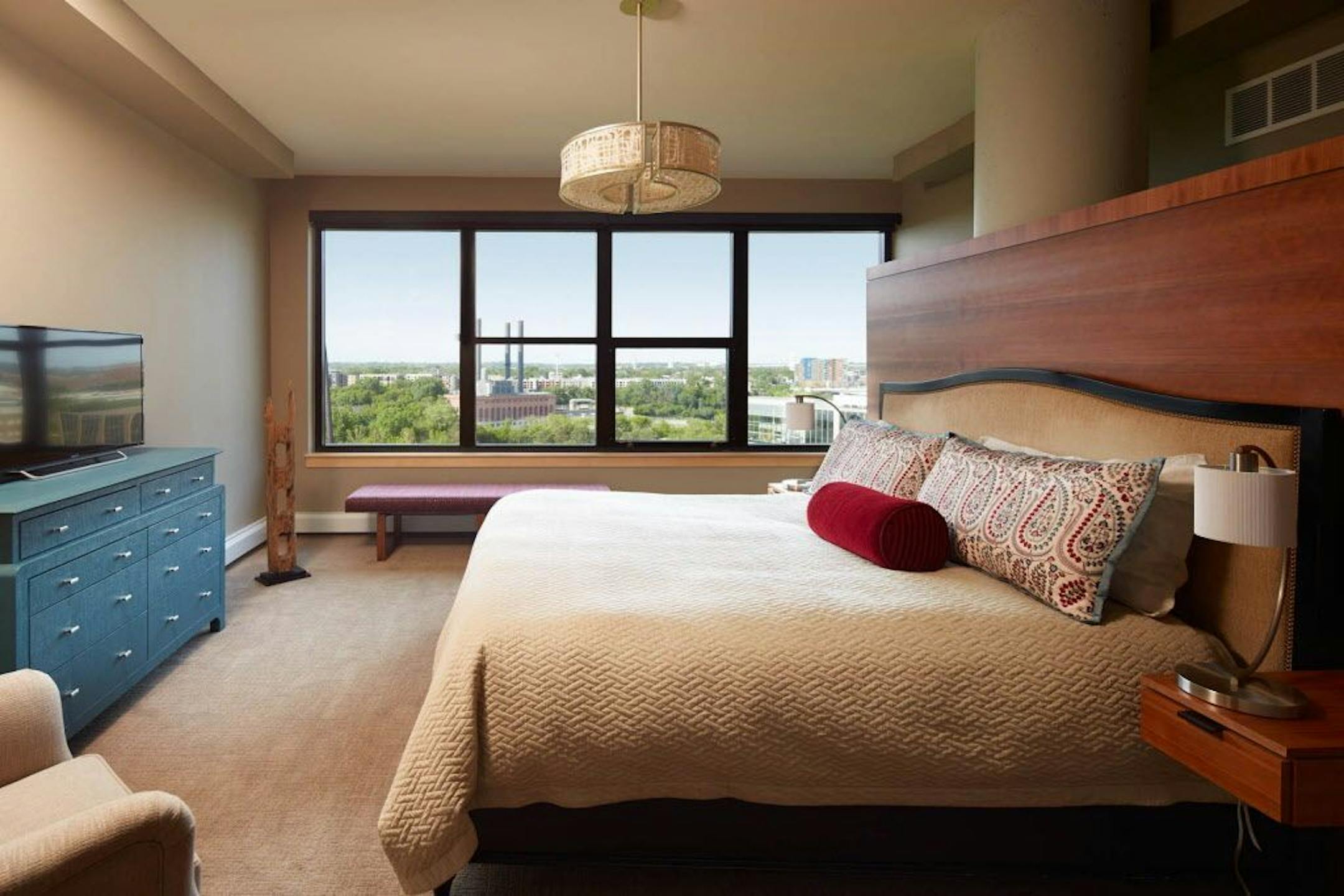 Bedroom solution: A custom cherry veneer built-in next to an existing concrete column created a wall for the bed - and more storage space.