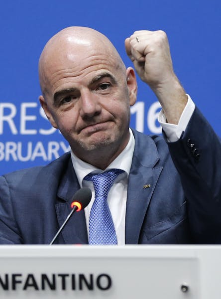 Newly elected FIFA president Gianni Infantino of Switzerland raises an arm during a press conference after the second election round during the extrao
