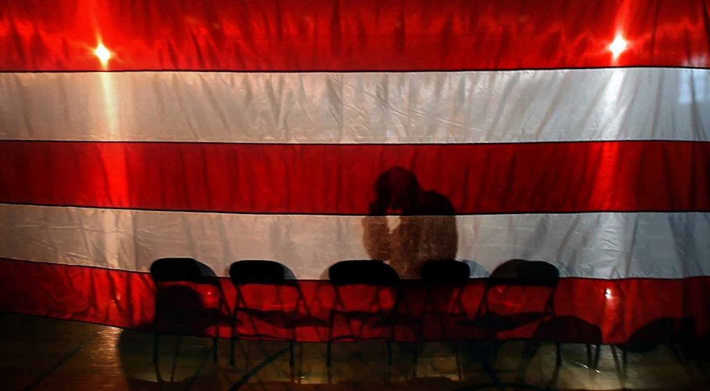 About 70 Minnesota National Guard soldiers and their families gathered in New Ulm recently for a deployment ceremony as members of the 1st Battalion, 125th Field Artillery prepare for deployment in Kuwait as part of Operation New Dawn. Following the ceremony, spotlights cast shadows of those who passed by a huge, American flag on the stage where troops and their families had been invited for a post-ceremony reception.