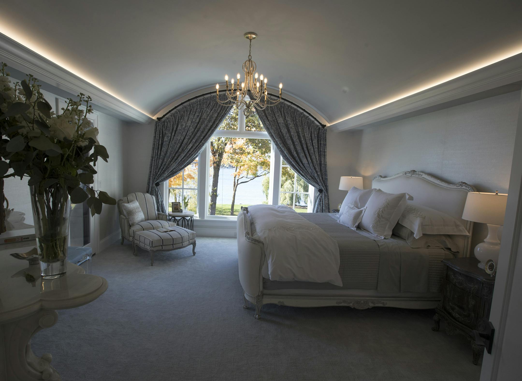 The master suite, designed by Angela Parker and Karen Soojian, features a barrel-vault ceiling and cove lighting.