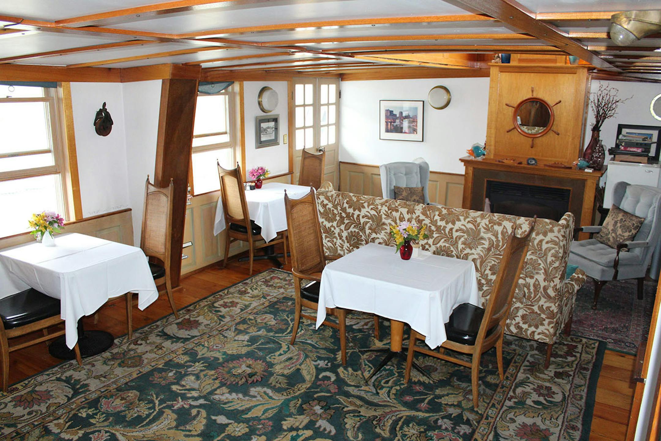 Innkeeper and owner Liz Miller serves her guests breakfast in the salon, which was the towboat's old engine room.