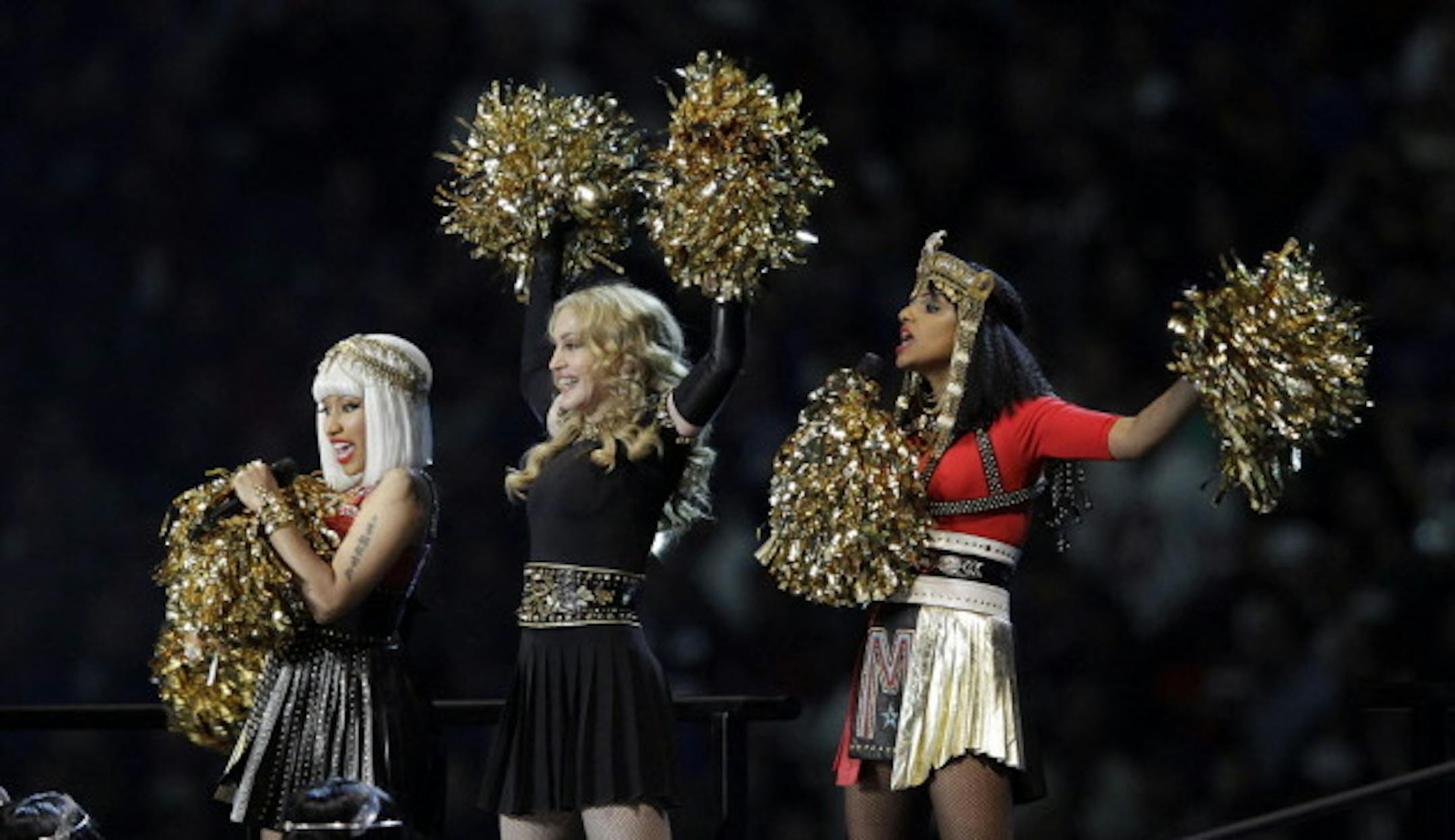 M.I.A., right, is stealing headlines from Madonna this morning off last night's Super Bowl half-time show. / AP photo, Michael Conroy