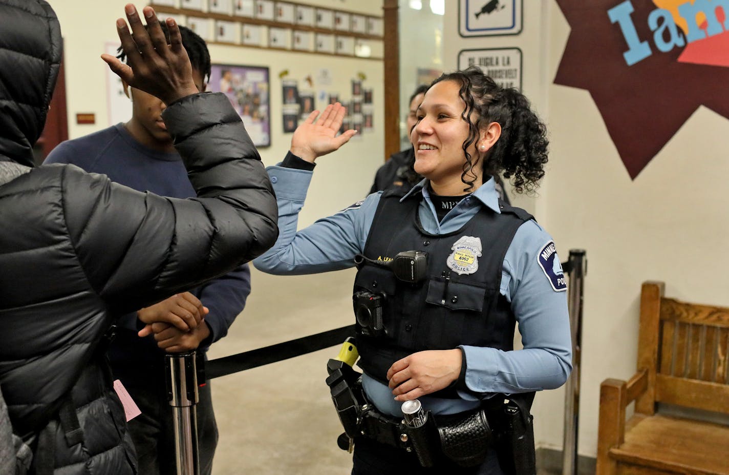 Minneapolis Police officer and school resource officer Drea Leal does a handshake with a passing student as she does her rounds in the hallways Friday, Jan. 18, 2019 at Minneapolis Roosevelt High, in Minneapolis, MN] DAVID JOLES &#x2022; david.joles@startribune.com A debate is brewing over the use of Minneapolis police officers in the city's public schools. Students for Education Reform recently petitioned the school board, calling for changes in how school resource officers are used. They want