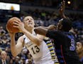 Marquette's Henry Ellenson tries to drive past DePaul's Rashaun Stimage during the first half of an NCAA college basketball game Wednesday, Jan. 20, 2