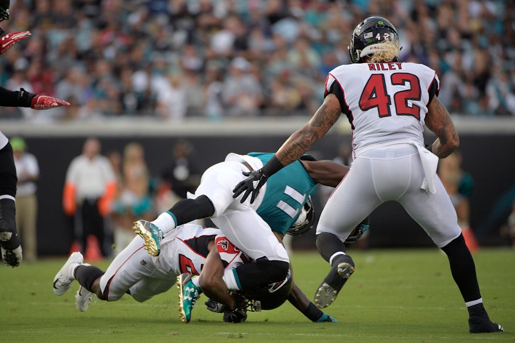 Jaguars wide receiver Marqise Lee is hit by Falcons cornerback Damontae Kazee