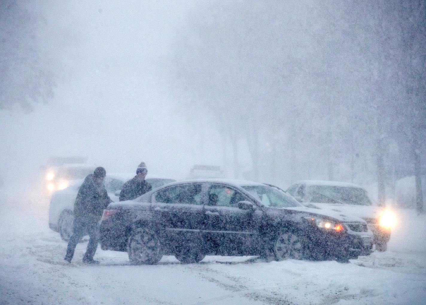 A car stuck halfway up the hill on Ramsey Street gets a push from a good samaritan.