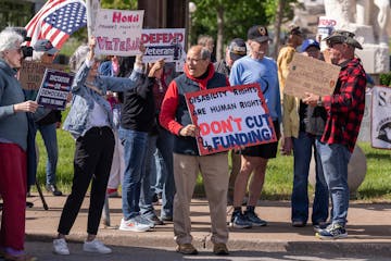 Protesters attend a rally at the Veterans Services Building in St. Paul on Thursday, demonstrating against the Trump administration's policies regardi